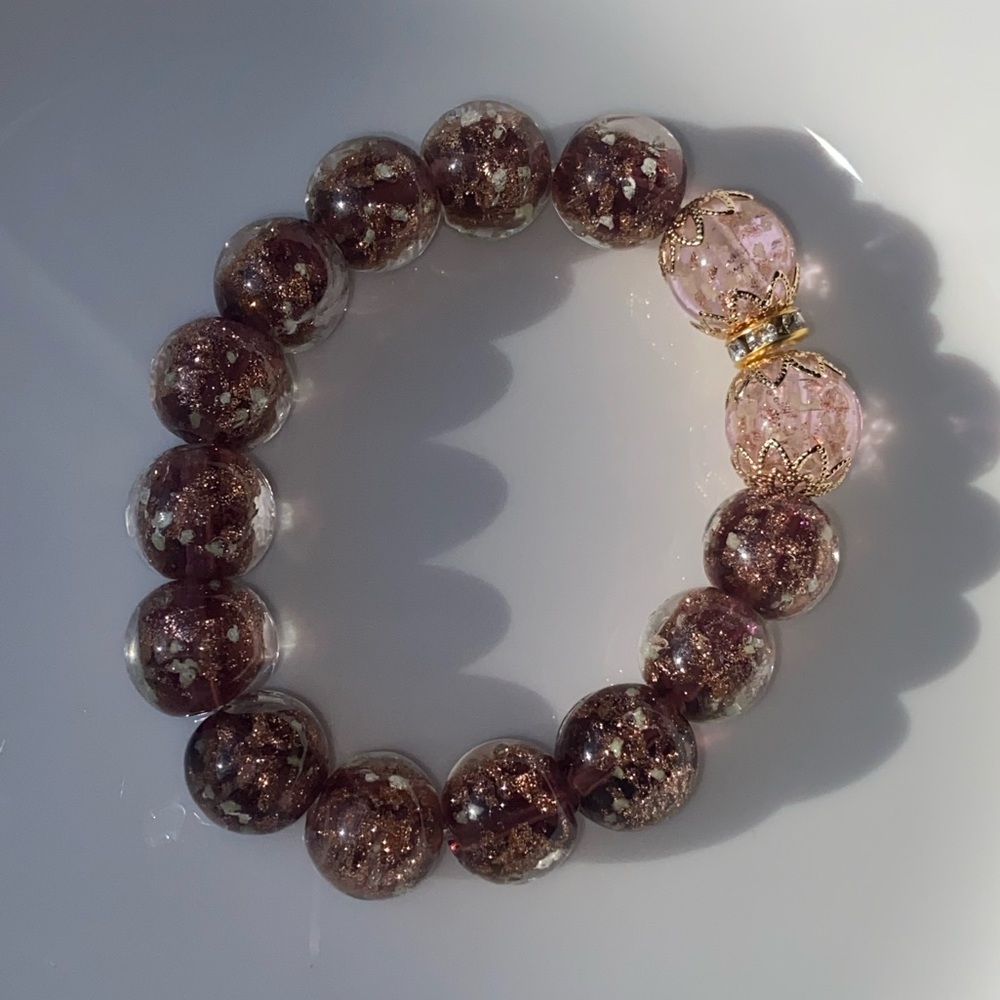 Beautiful bracelet with pink glass beads and gold foils